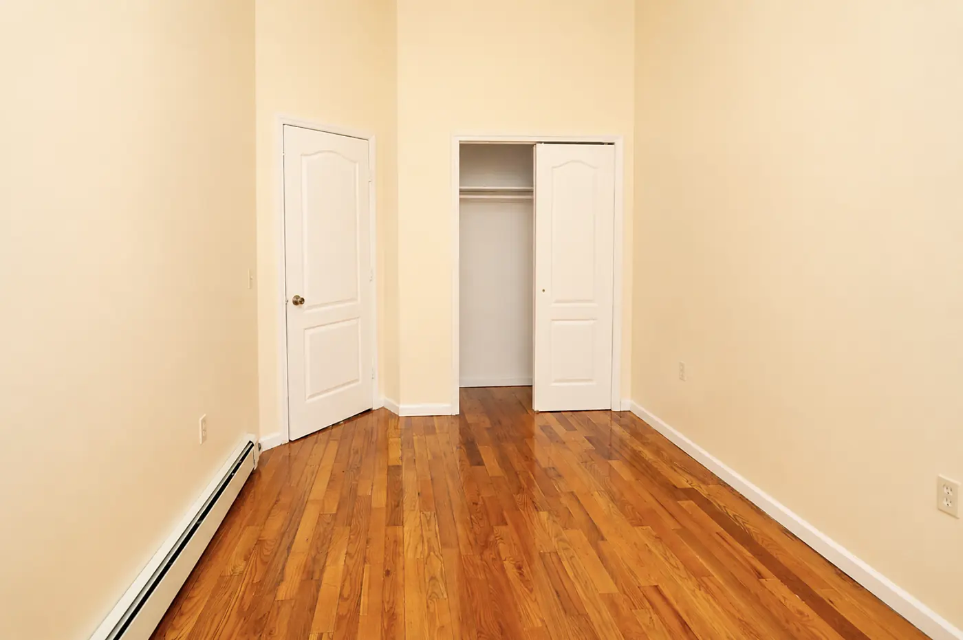 Second bedroom with a closet and hardwood floors